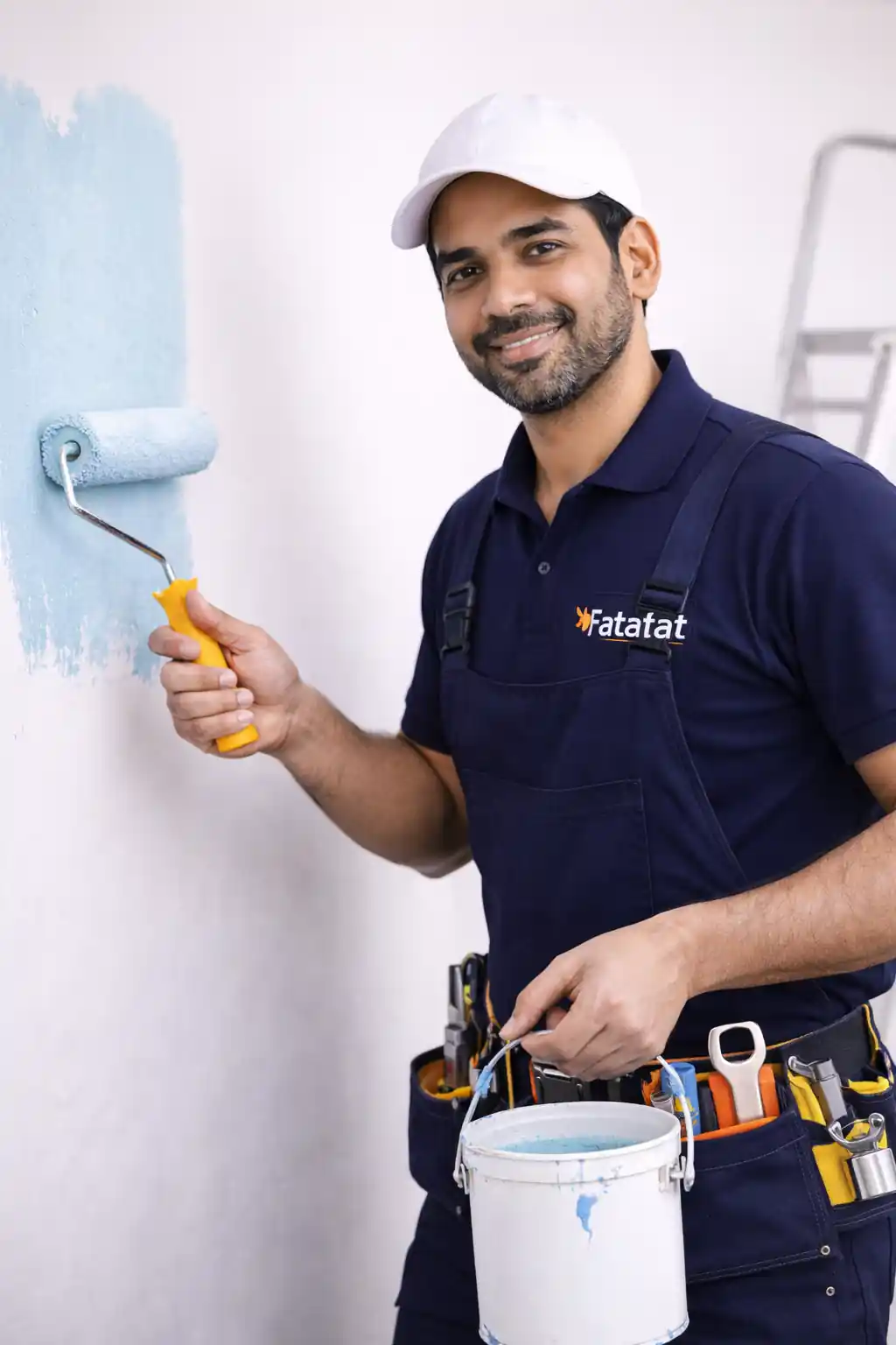 Indian painter painting wall in Fatafat uniform